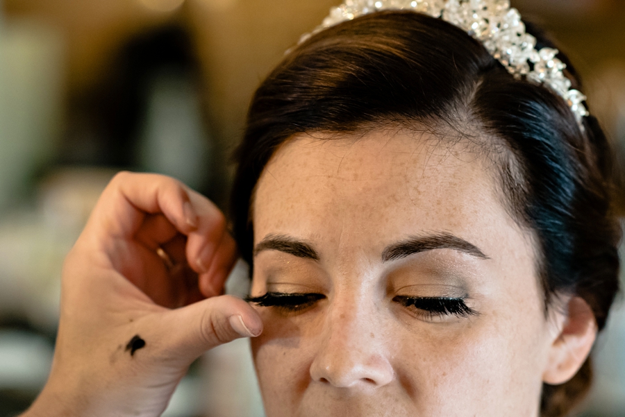A bride getting extra lashes on her wedding day.